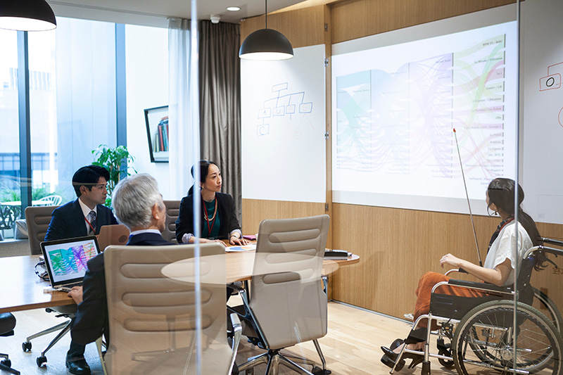 Caucasian women using a wheelchair presenting to a group 