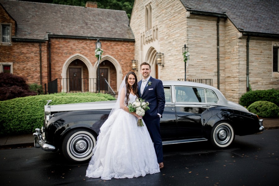 Photograph of bride and groom in front of Rolls Royce automobile and Graystone Presbyterian Church in Knoxville Tennessee