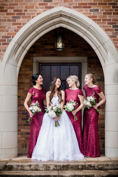 Photograph of a bride and bridesmaids under an arch at Graystone Presbyterian Church in Knoxville Tennessee