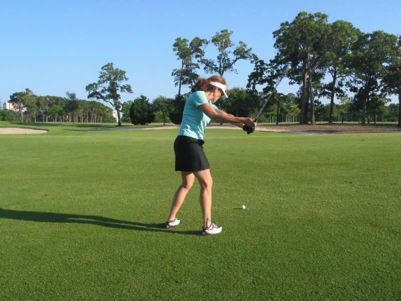 female golfer swinging club