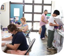 Photo of volunteers working at the Brooke It Forward office